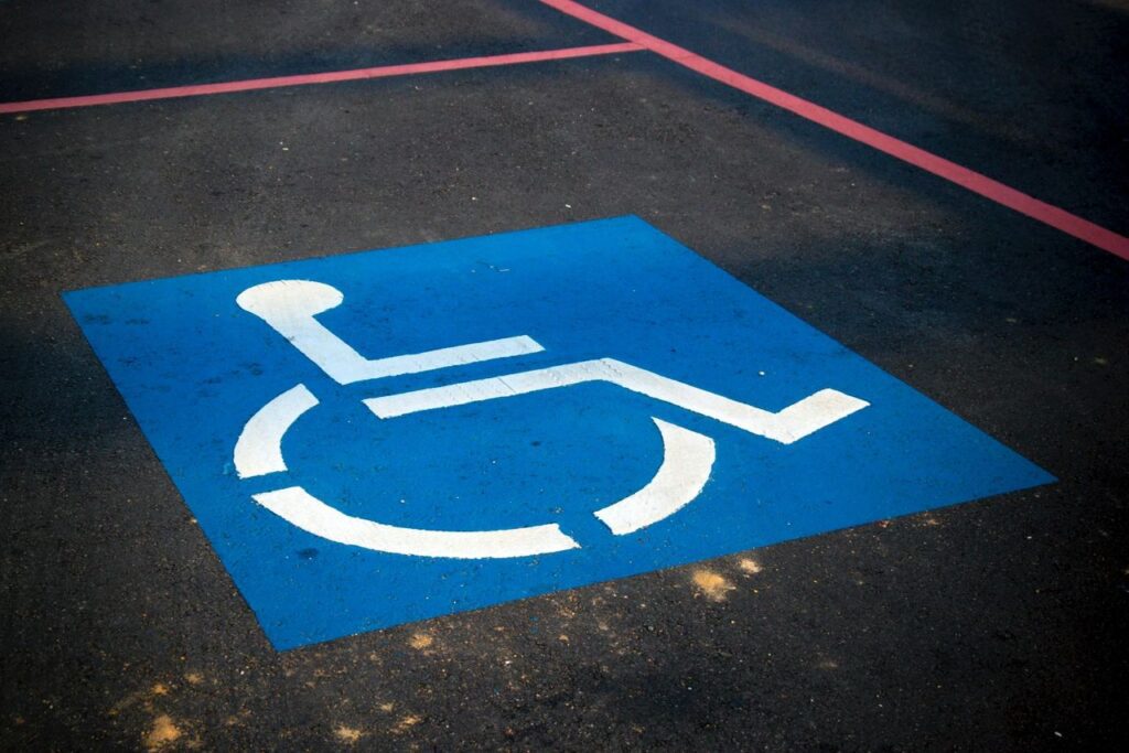 Handicap sign on road in blue color